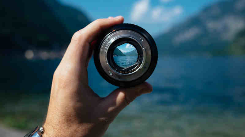 Holding a lens to see the small part of larger goal in web development | CoencE Web Development & Marketing
